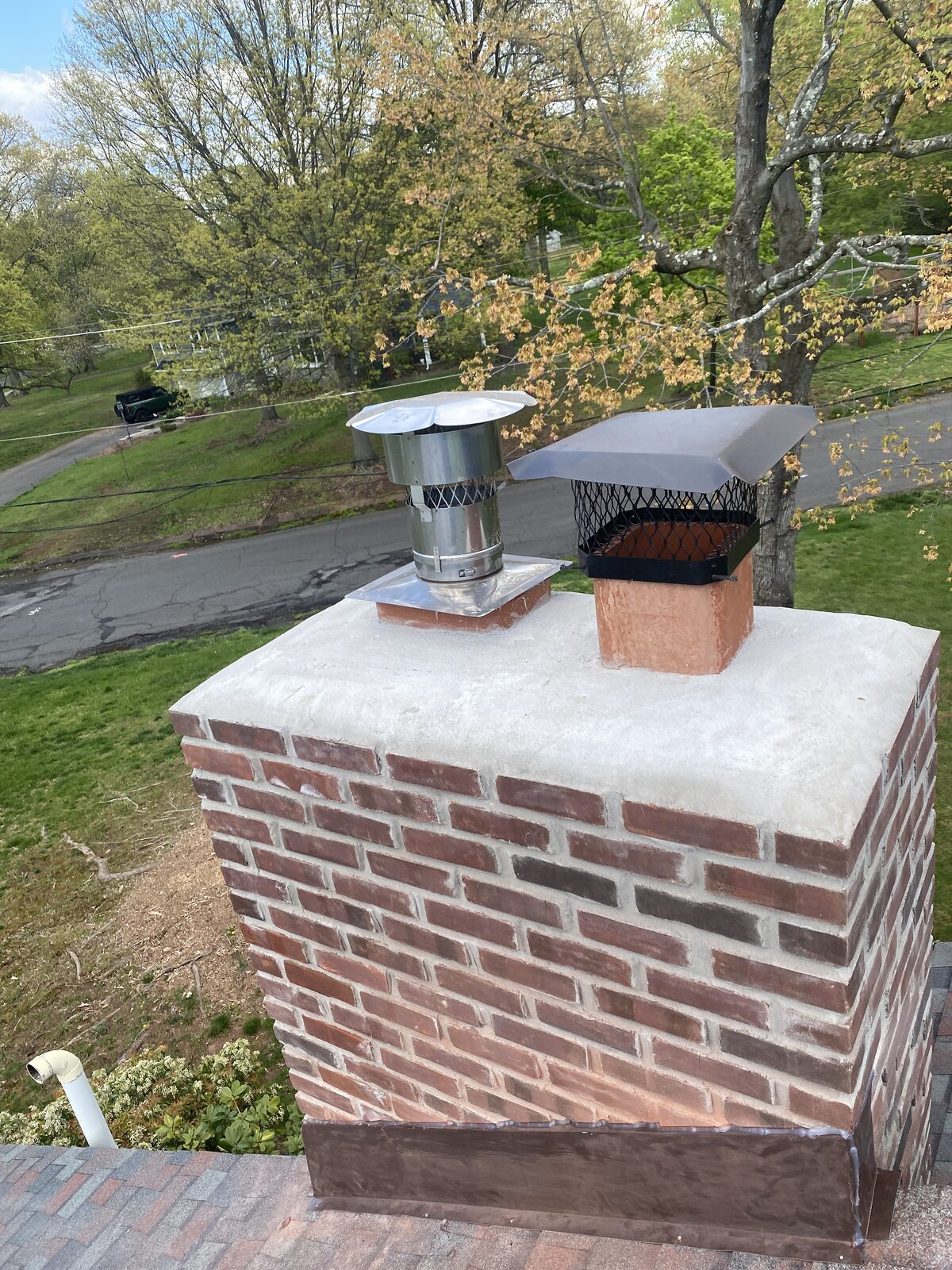 Restored red brick chimney with new crown and caps